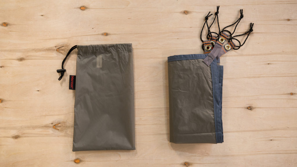 Footprint with stuff sack on wooden surface