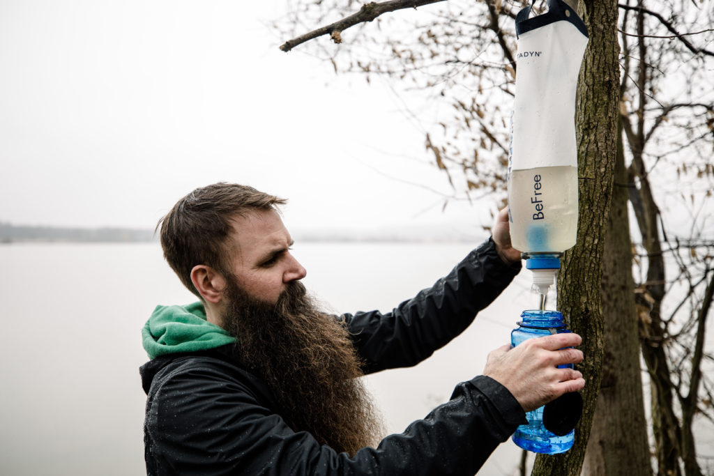 Steven using a Katadyn gravity filter along a Pennsylvania river