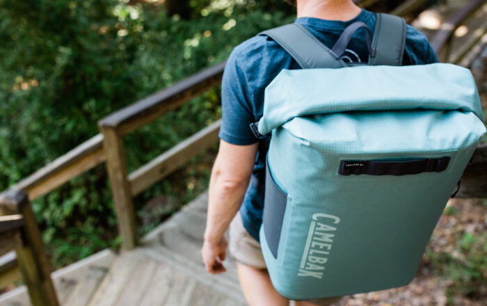 Man walking down steps with backpack