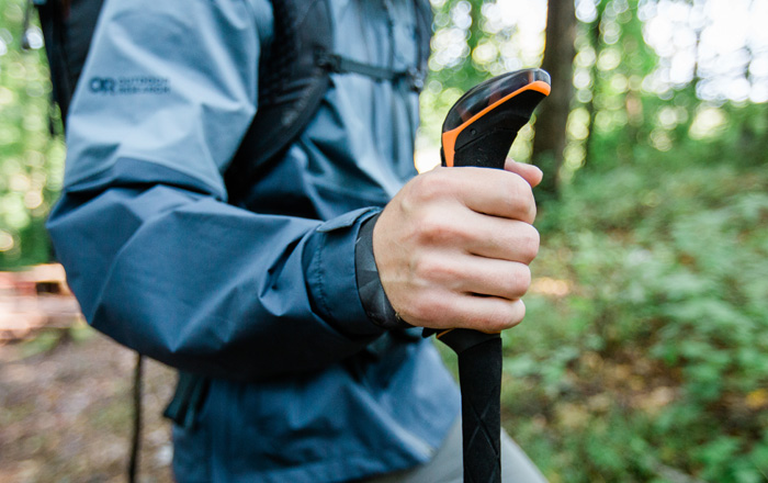 Hiker outdoors holding trekking poles