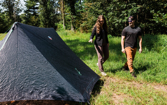 two people with backpacking tent outdoors