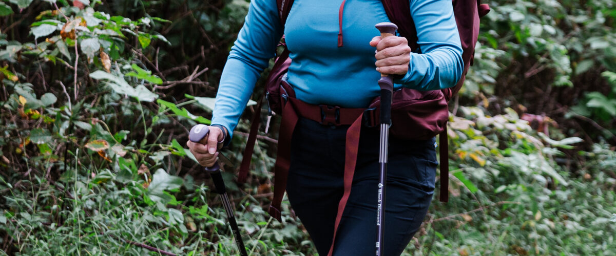 woman hiking with trekking poles