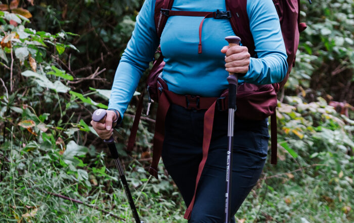 woman hiking with trekking poles