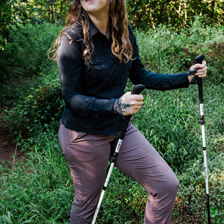 woman outdoors with trekking poles