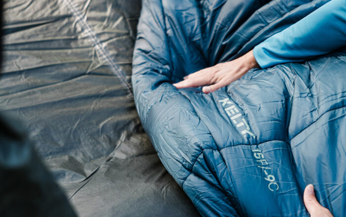 Person camping with Kelty sleeping bag