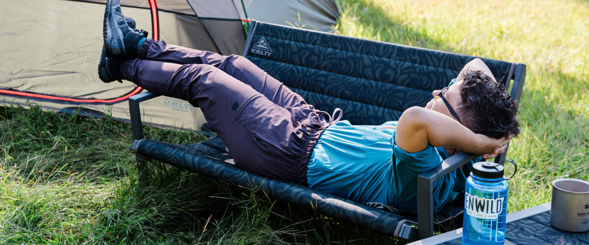 person outdoors camping using Kelty Rad Loveseat