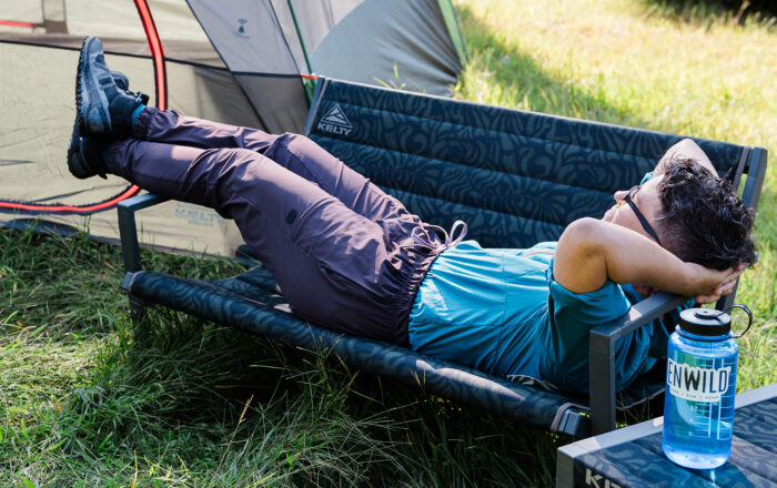 person outdoors camping using Kelty Rad Loveseat