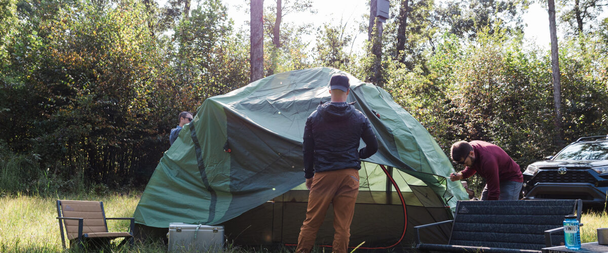 people setting up campsite outdoors