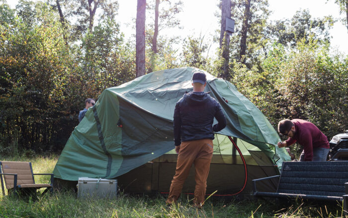 people setting up campsite outdoors