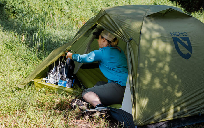 woman outdoors camping in tent
