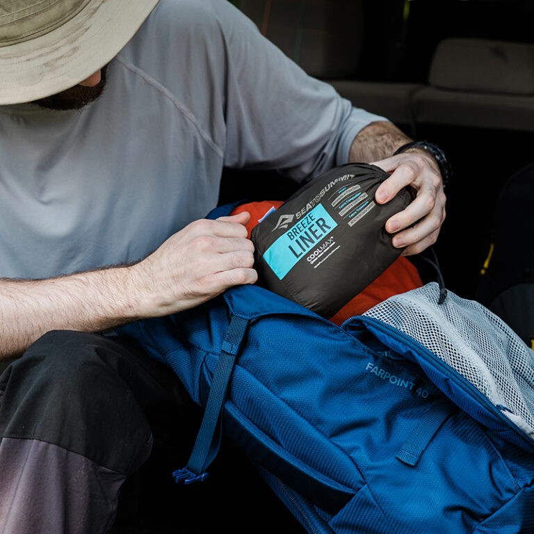 Person with sleeping bag liner