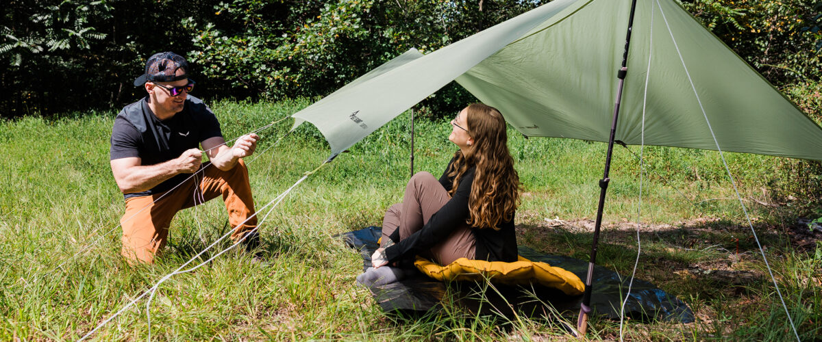 Two backpackers setting up camp
