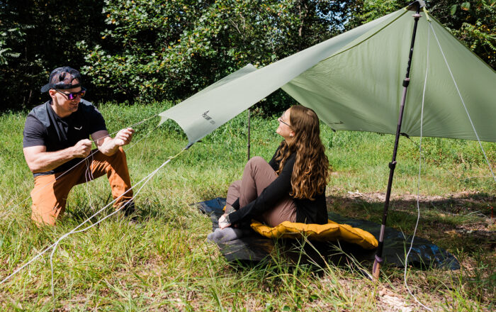Two backpackers setting up camp