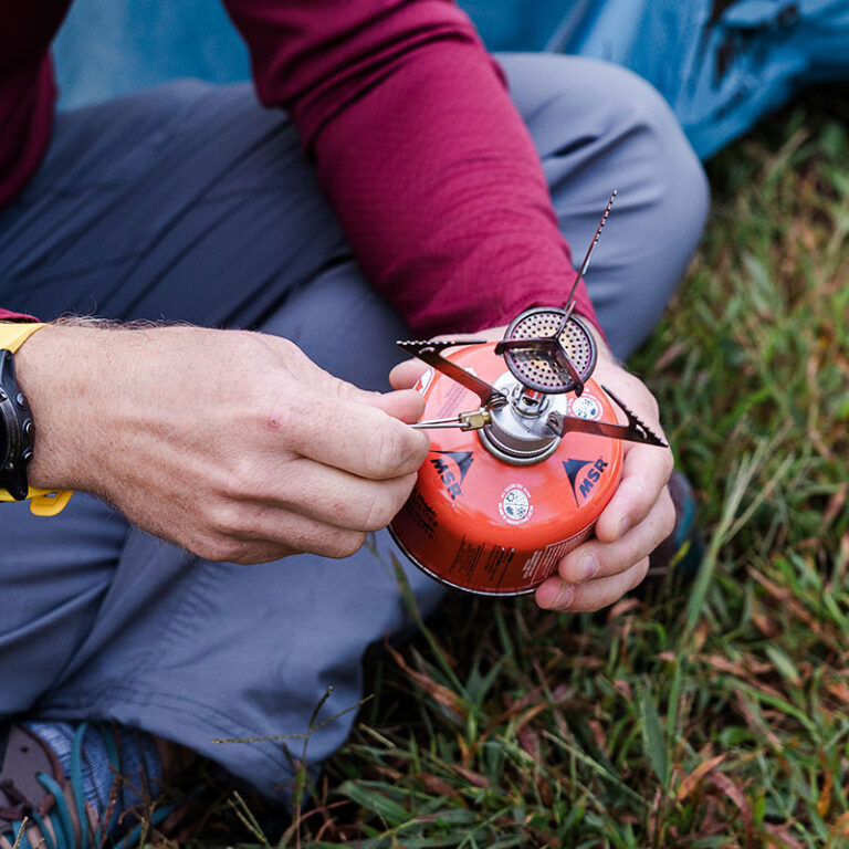 person holding camp stove
