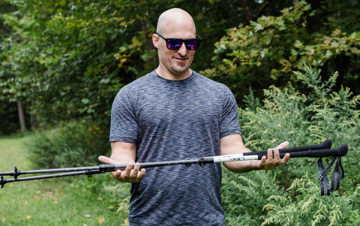 Man outdoors holding LEKI trekking poles